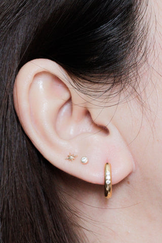 Gold hoop earrings with embedded diamonds from the two tone wynning reversible hoops collection