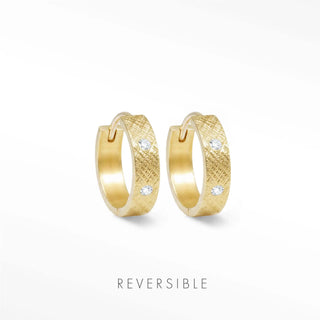 Gold-toned huggie earrings with textured surface and three clear gemstones | huggie earrings gold by wynning reversible hoops