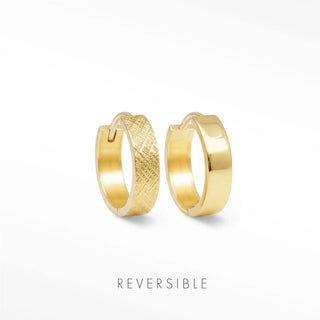 A pair of reversible gold Florentine huggie earrings featuring one textured and one polished smooth hoop