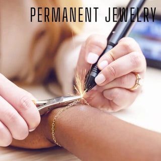 Gold chain bracelet being engraved with a permanent pen for a bespoke jewelry experience gift