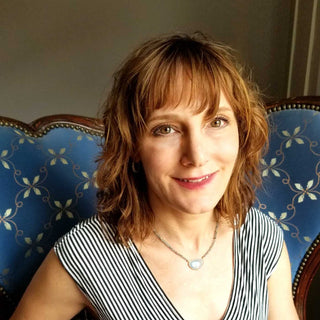 Jewelry stylist creating a custom curated ear design with fine jewelry