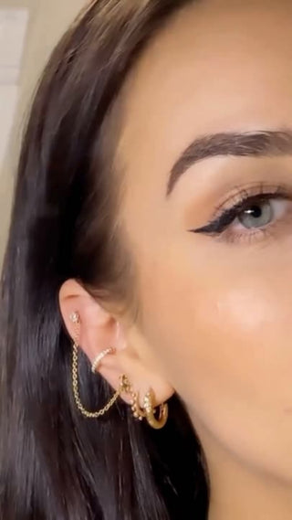 customer wearing gold hoop earrings at jewelry store in denver