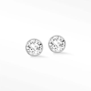A pair of elegant lab grown diamond studs bezel set in polished 14k white gold for timeless sophistication