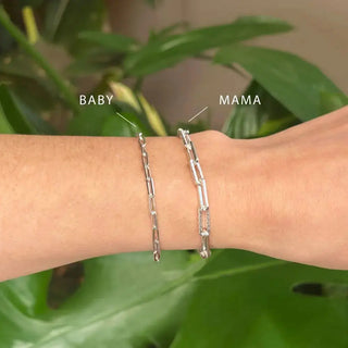 Silver chain-link bracelets including a baby and mama paperclip silver bracelet worn on wrist in 8 inch size