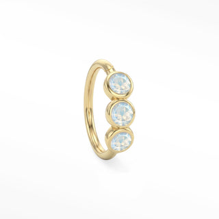 14K yellow gold trio seam ring with three round bezel-set moonstones aligned along the hoop