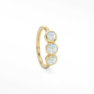 14K yellow gold trio seam ring with three round bezel-set moonstones aligned along the hoop