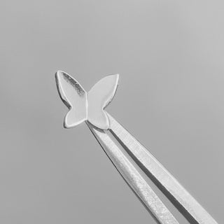 Butterfly flat back earrings, in 14k white gold, a delicate butterfly motif design and finish.