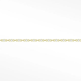A 14k yellow gold chain with prismatic tiny diamonds in an oval link design for permanent jewelry use