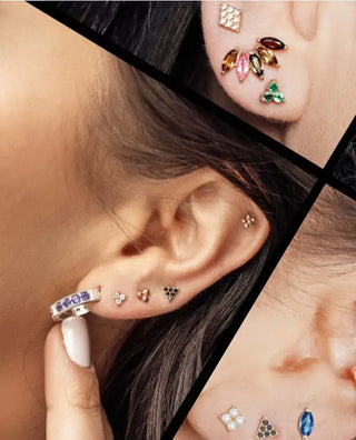A silver hoop earring adorned with a row of purple gemstones.