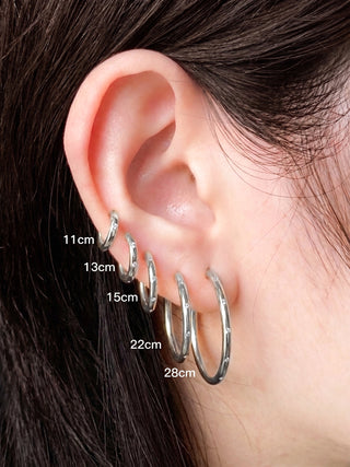 A set of five silver hoop earrings with subtle textured edges from Ellie Silver Hoop Earrings Wynning reversible hoops