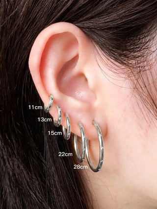 A set of five silver hoop earrings with subtle textured edges from Ellie Silver Hoop Earrings Wynning reversible hoops