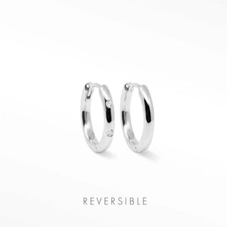 Ellie silver hoop earrings by Wynning feature reversible design with two small clear gemstones on each side