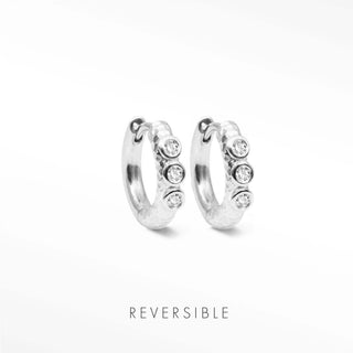 Telletubies silver hoop earrings featuring three clear round stones set along the outer curve of silver hoops