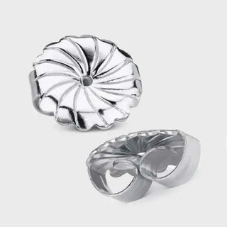 Silver-toned, intricately designed earring backs with a petal-like pattern and polished metallic finish.