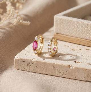 Pair of Diana pink sapphire huggies showing marquise gemstone accents