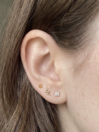 Snake earrings with a flat back design in 14k solid gold. Hypoallergenic secure and comfortable for daily sleep wear.