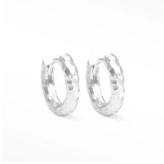 Hammered sterling silver hoop earrings featuring a textured faceted surface with a silver hammered finish