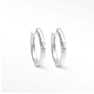 Hammered sterling silver hoop earrings with a textured hexagonal pattern in silver hammered hoop design