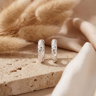 Pair of hammered 15mm silver hoops displayed upright