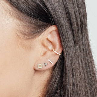 Gold-toned 14k yellow stud earrings with flat backs and pave-set crystals in geometric and hoop designs