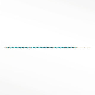 Turquoise gemstone beads close-up; metal fittings are outside the crop
