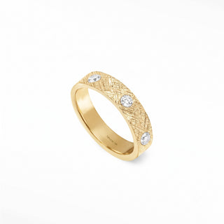Delicate 14k gold cigar band ring featuring a textured woven pattern and four small round band ring diamonds